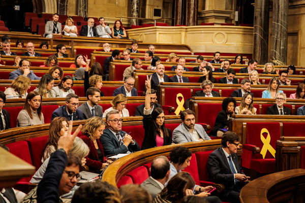 Votació al Parlament sobre la moció d'immigració amb diputats al fons.